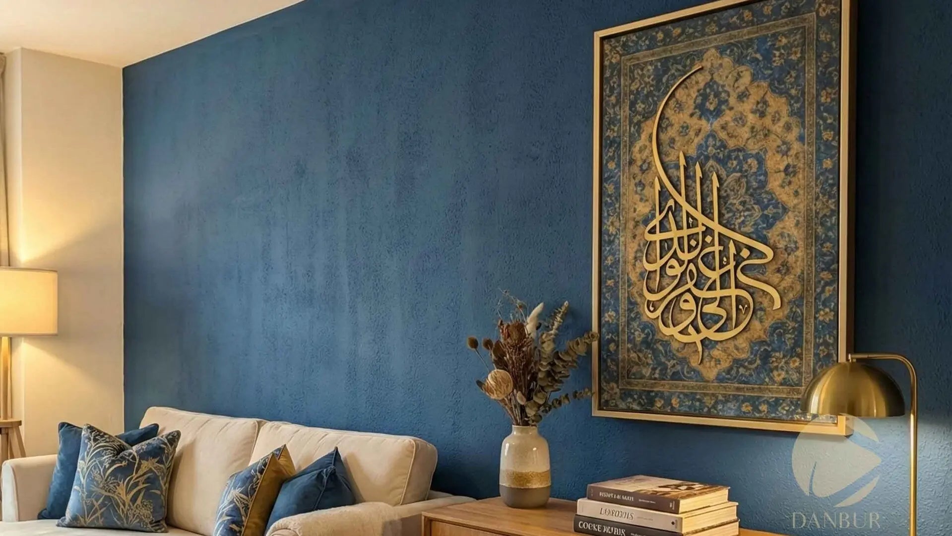Living room with blue wall, beige sofa, and decorative wall art featuring Arabic calligraphy.